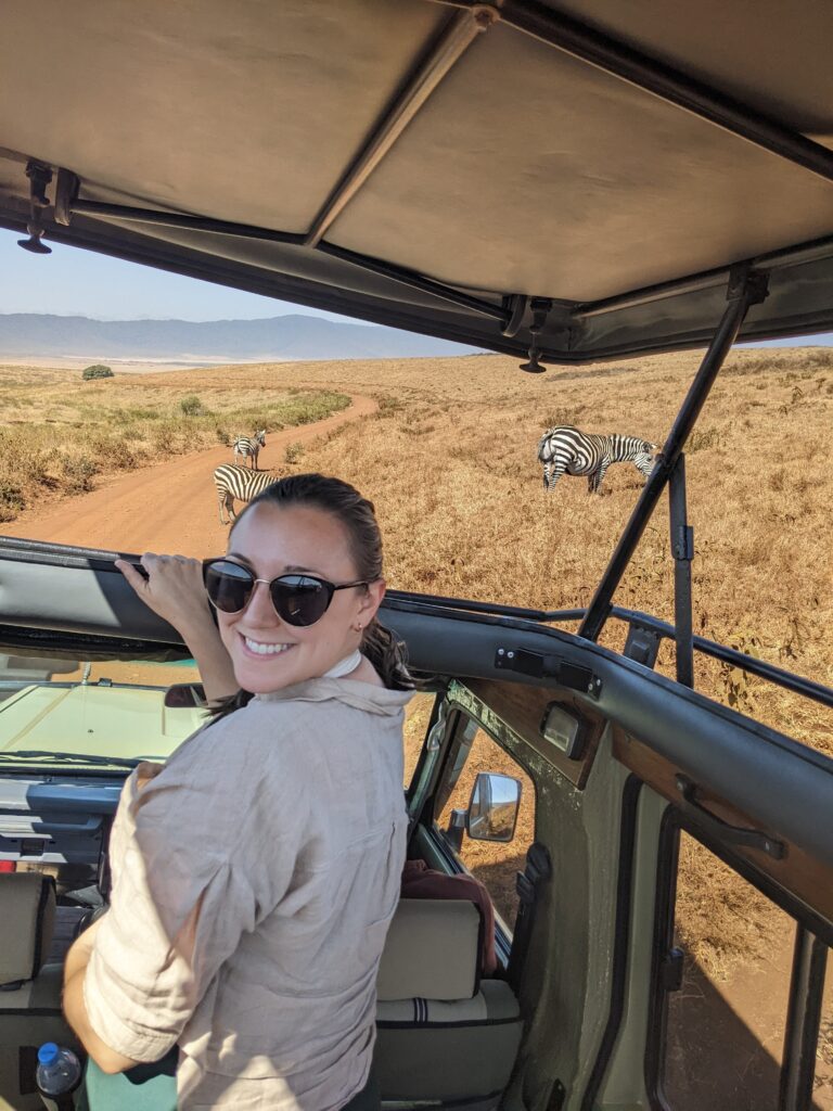 girl on safari with zebras
